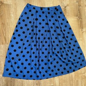Large pleated blue polka dot skirt